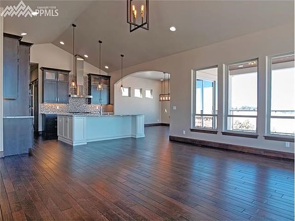 View from great room to the gorgeous kitchen with lots of sitting apace at counter bar