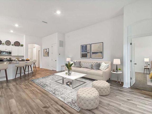 Sweetwater new construction home plan interior open concept family room at Lanier Acres in Zephyrhil