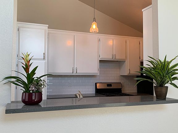 Kitchen opens up to living and dining room, cool bar top