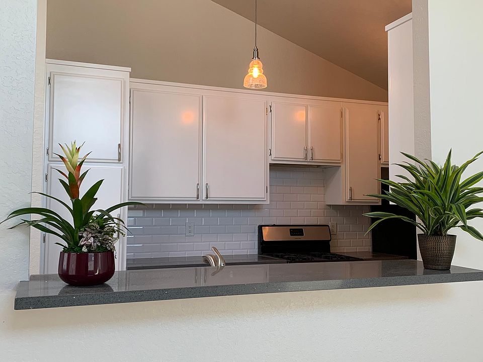 Kitchen opens up to living and dining room, cool bar top