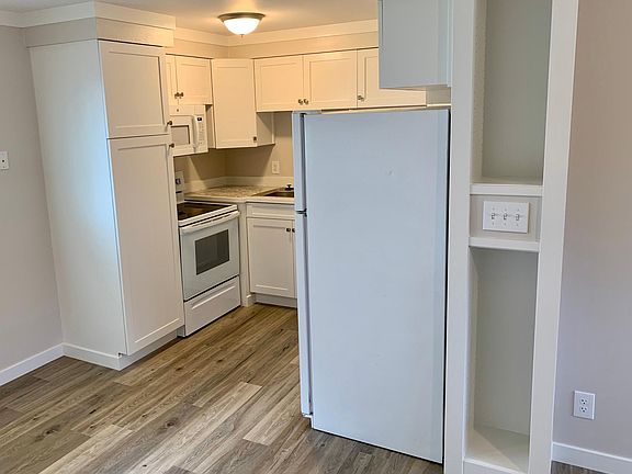 New kitchen with new dishwasher, microwave, oven, sink, and lots of cabinet space.