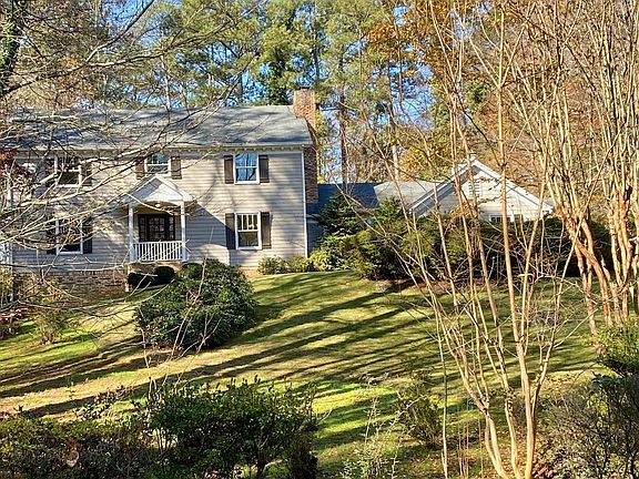 Front of home features large landscaped yard