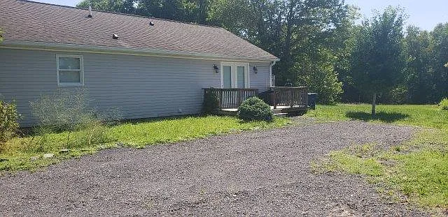 Entrance with deck and parking