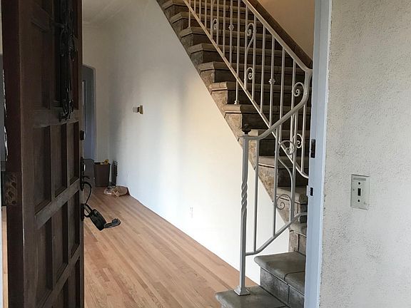 stairs to upstairs bedrooms. Look at those hardwood floors.