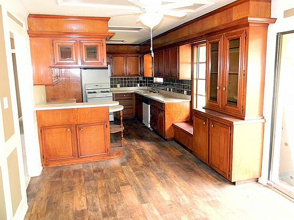 Great kitchen space with lots of cabinets and counter space including stove and dishwasher and dual sinks. Lovely black tile backsplash and sit down bench with full window panel.