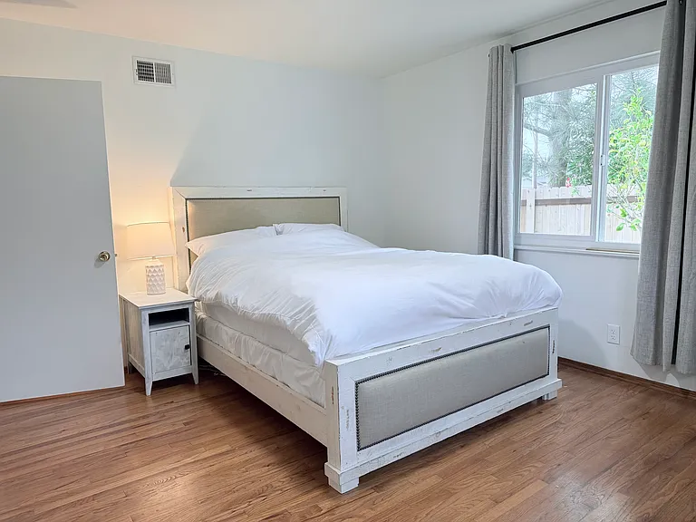 Queen bedroom with work station with standing desk.