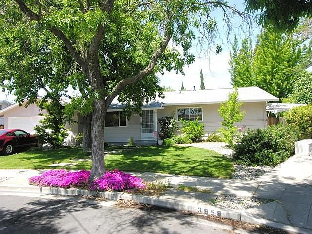 Front of home with mature trees.