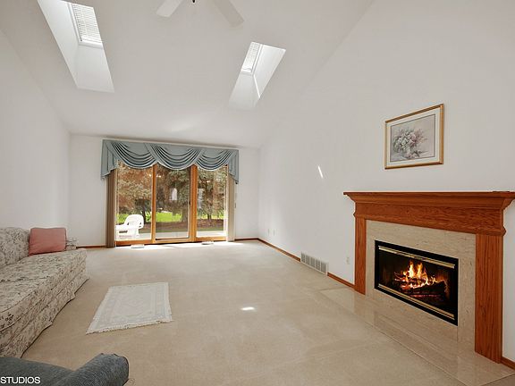 Lovely glass doors to the private patio! Enjoy the gas log fireplace from every angle!
