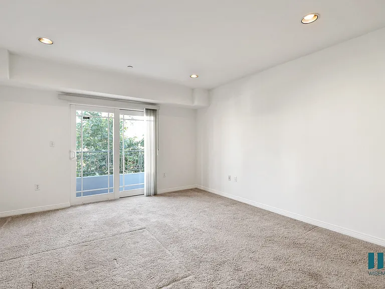 Spacious Bedroom with Recessed Lighting, Carpet, and Balcony