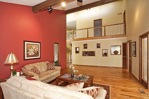 Spacious living room has gleaming wood floors