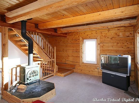 living room with tongue and groove ceiling, wood stove - stairs to master 