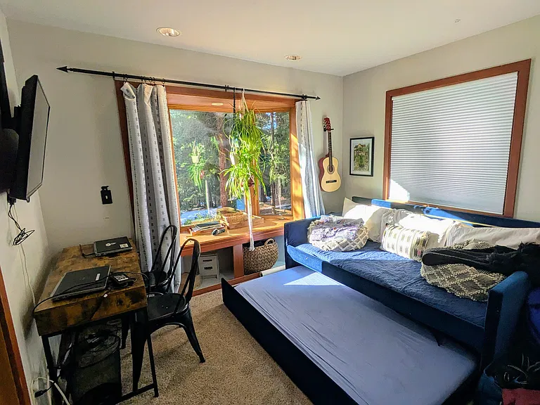 4th bedroom is also downstairs and offers desk space, a trundle bed, closet, and sunny bay window + second window