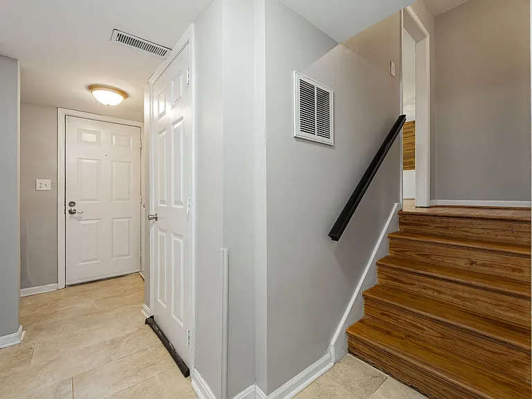 Downstairs hallway and stairs to mid-level
