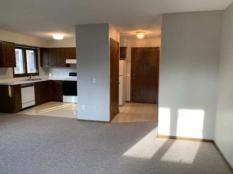 Entryway, coat closet, kitchen from living room perspective