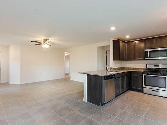 Gorgeous upper-wood cabinets with crown molding provide plenty of storage space