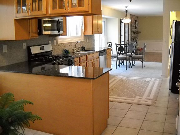 Kitchen looking into informal dining & family room