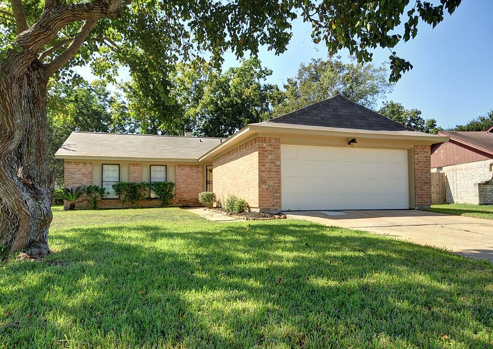 Great totally updated brick home with mature trees and huge yard! Back yard fully fenced with covere