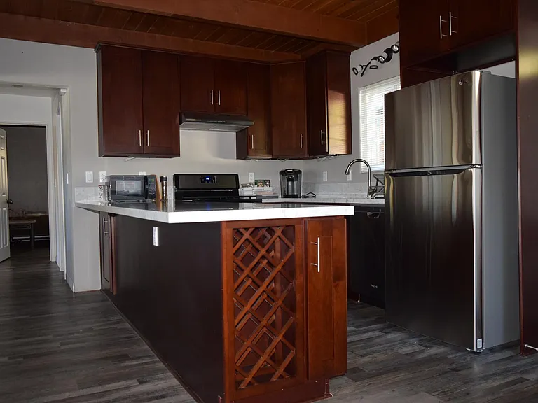 A place for everything, and everything in its place (like wine bottles). Also, the counter overhang gives you space to place a few stools when entertaining guests.