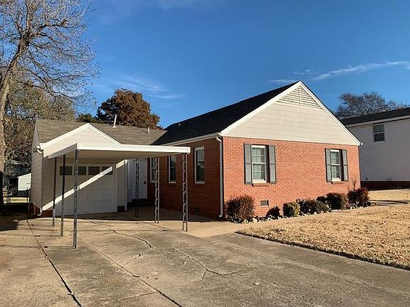 1-car garage with a new garage door opener and car port