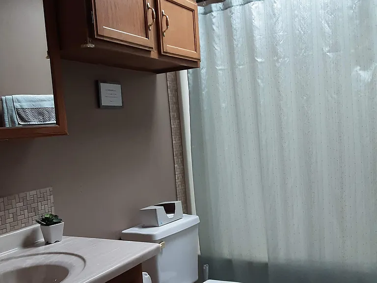 Spare bath with basic necessities and towels in cupboard
