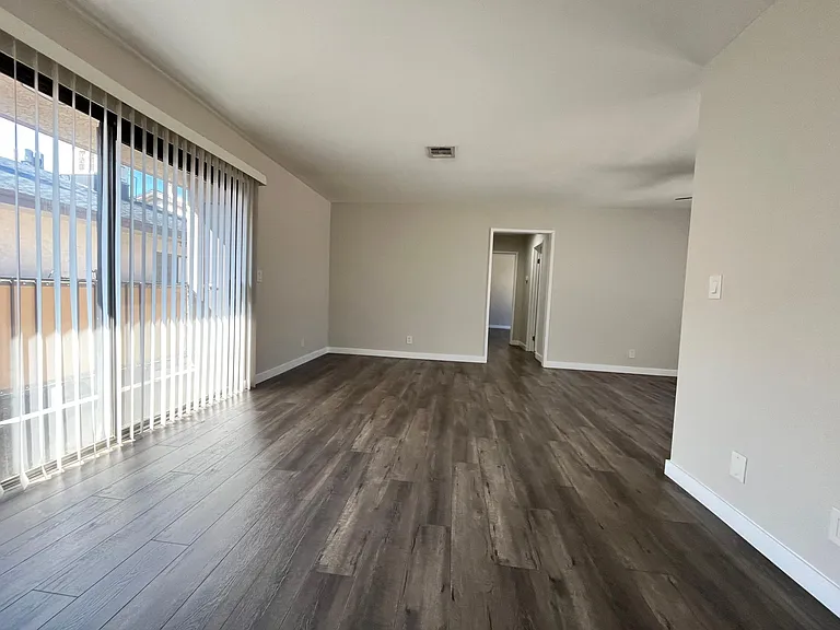 Open concept living & dining space, with private balcony
