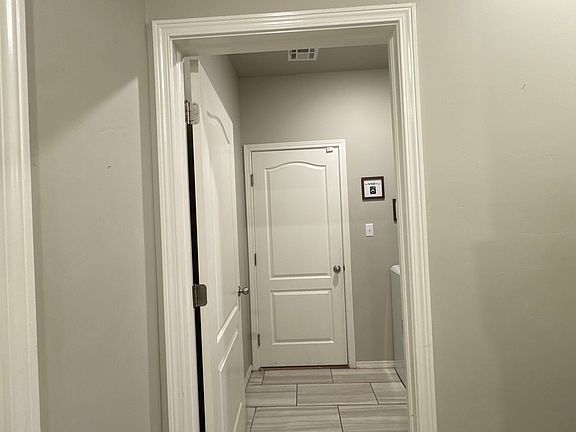 Walk way into the laundry room with garage door entry.