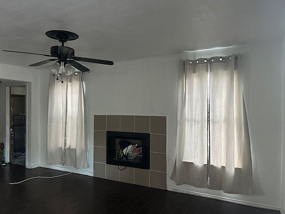 Fireplace and laundry room can be seen