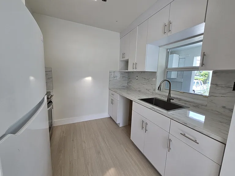 Completely updated kitchen looks out on the back garden