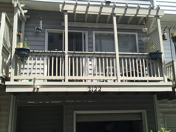 Back of house, balcony, and one car garage