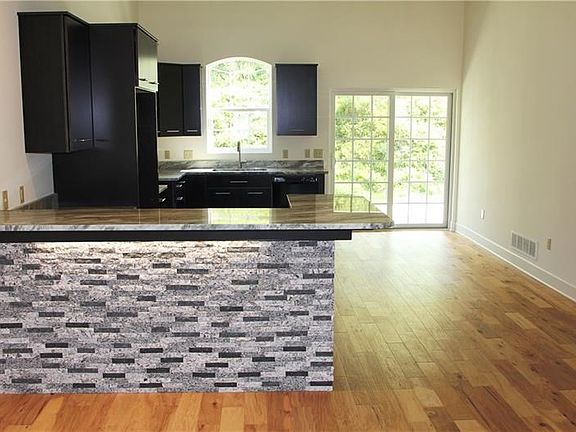 Gorgeous eat in kitchen with granite counter tops and sliding doors to the covered patio.