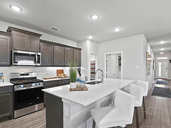 Kitchen in the Oscar home plan by Trophy Signature Homes - REPRESENTATIVE PHOTO