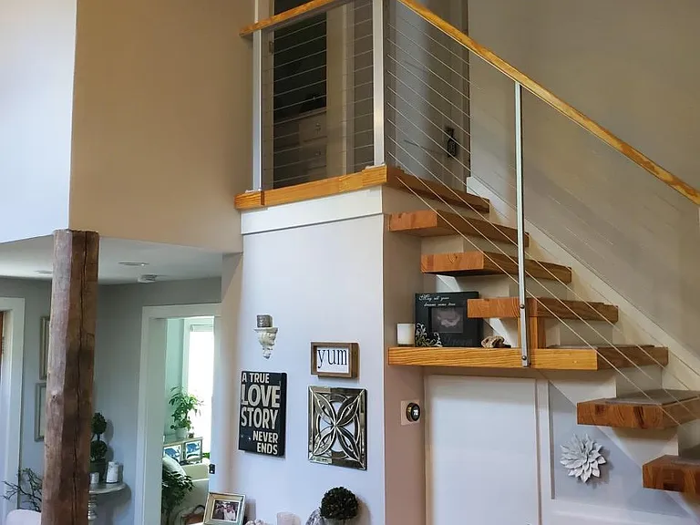 Stairs to 2nd floor with storage builtin below (full bath and 2 bedrooms)