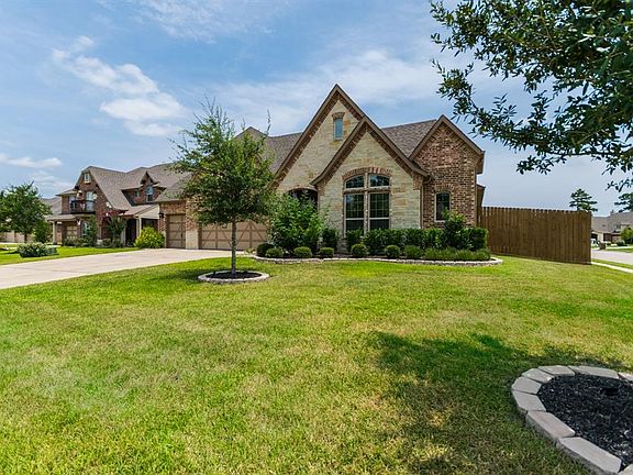 Oversized corner lot with manicured landscaping.