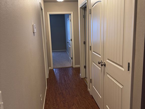 hallway to bedrooms - laundry closet on the right