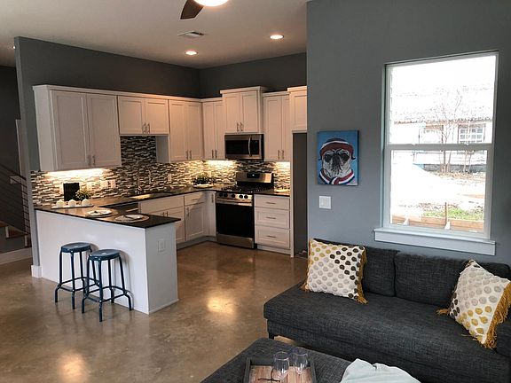 Luxurious chef's kitchen with black and stainless appliances