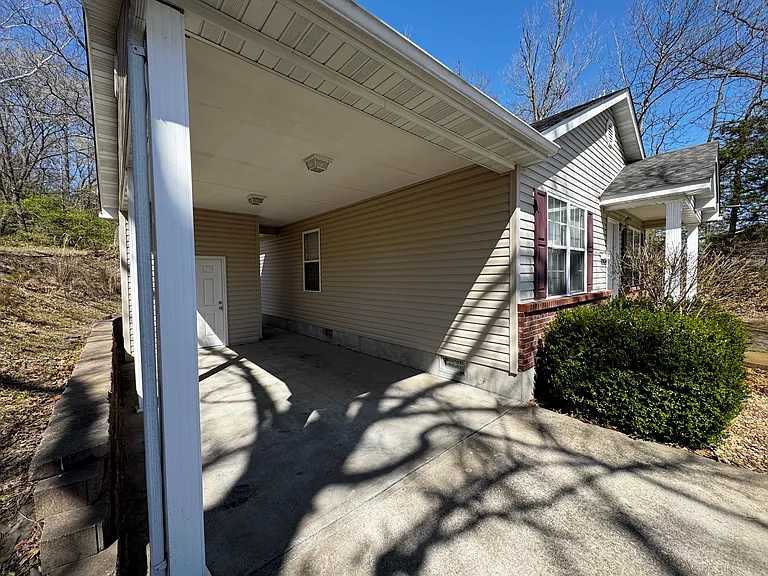 Large carport capable of housing a 3/4 ton truck.