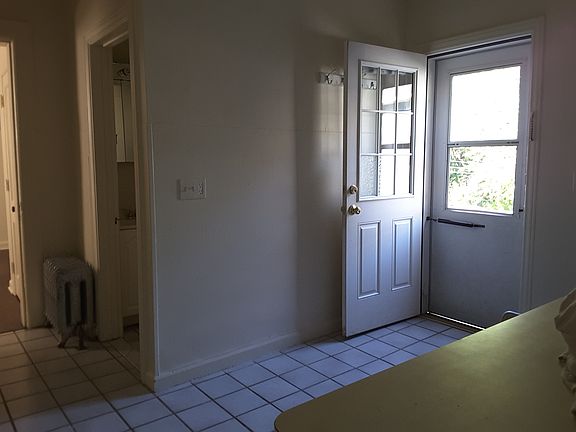 Kitchen facing back door to private deck. Ceramic floor.