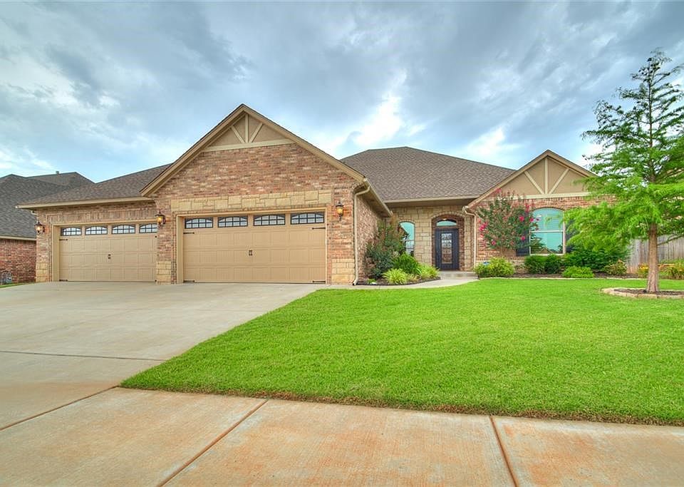 WOW!!!  4 is the #!  4 car garage and 4 bedroom home!!!! Landscaping is great!