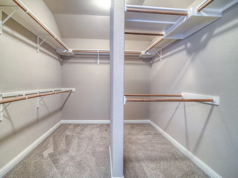 Not only is primary closet a true walk-in closet, is structured and organized for extra hanging space