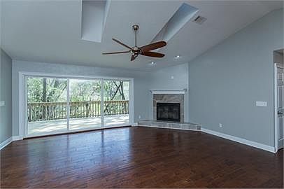 Great room with fireplace, and large sliding glass doors that open onto the deck