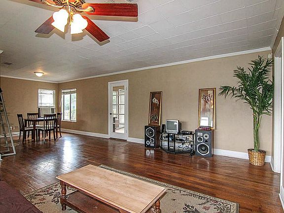 The main area is open and inviting with stunning hardwood floors and crown molding.