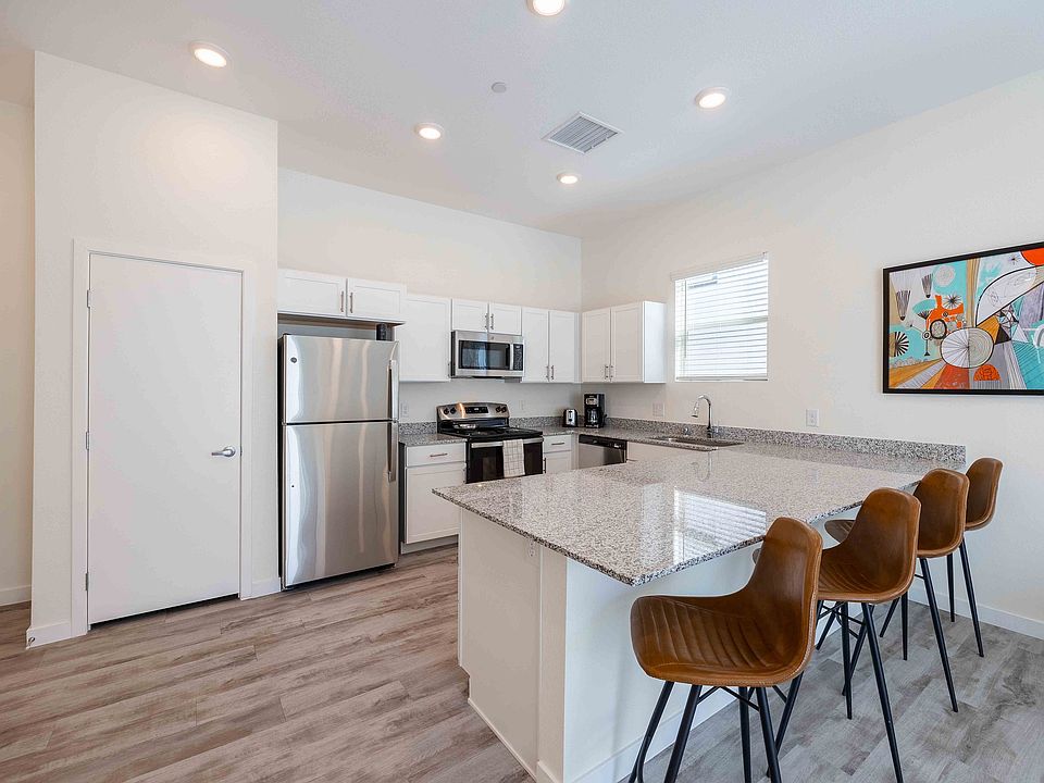 Explore this modern kitchen, where style meets functionality with granite surfaces and stainless steel appliances.