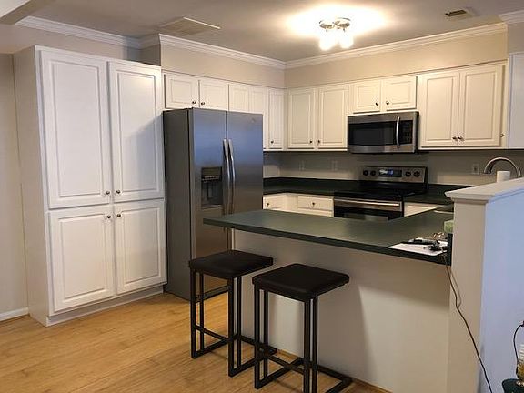 Kitchen area with stainless steel appliances and additional storage