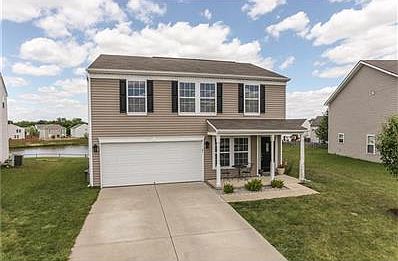 Meticulous two-story on low maintenance lot with your own stocked fishing pond