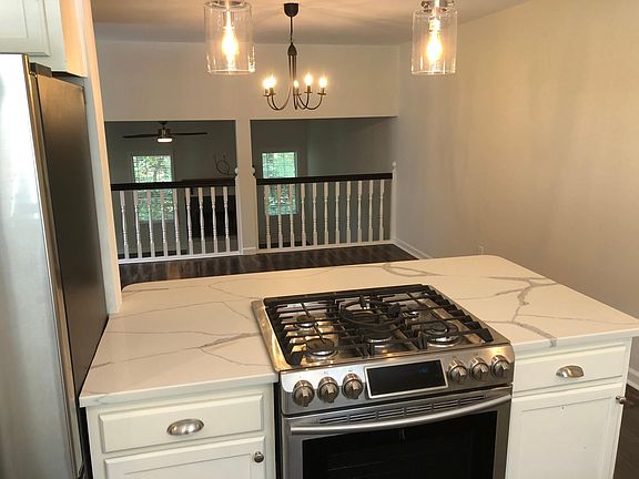 cooking island looking to dining room and living room beyond that