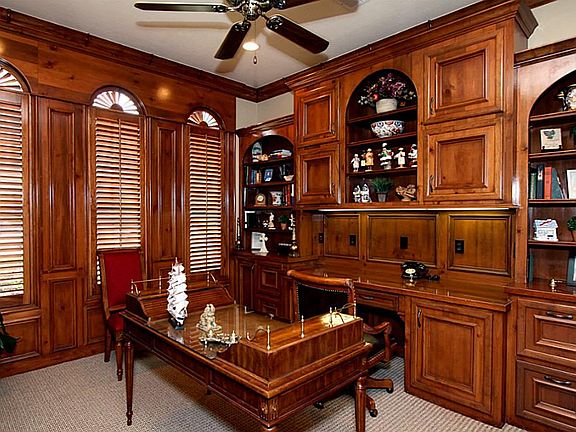 The homes study is replete with rich wood cabinetry and plantation shutters.