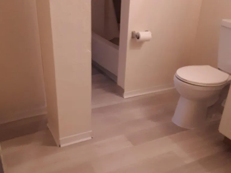 Apt 1 bathroom - looking towards shower, new flooring