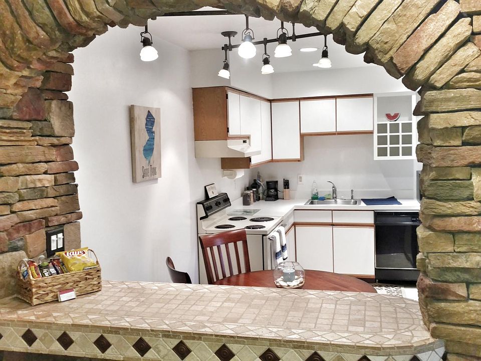 Custom real stone bar upon entering apartment