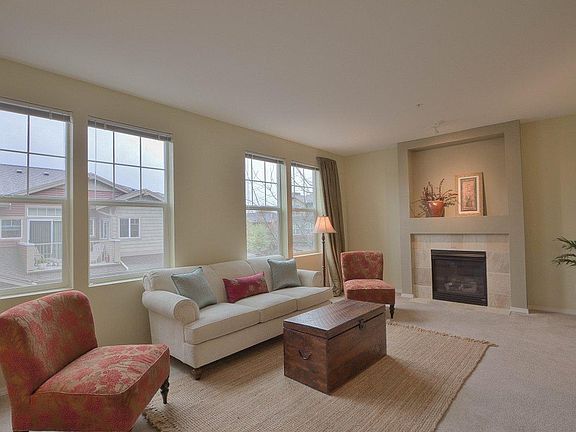 The living room runs full width of this home, there is more than meets the eye in the picture. Warm 