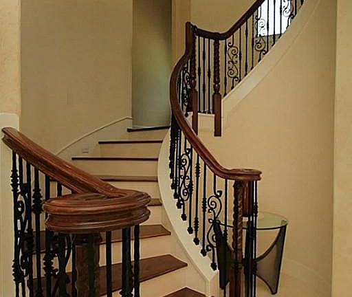 THIS IS ONE OF THE TWO STAIRCASES THAT LEADS YOU TO THE FANTASTIC SECOND FLOOR OF THIS HOUSE! IT'S LOCATED AT THE RIGHT HAND OF FOYER AND CONSISTS OF NATURAL WOOD FLOORS AND EXCLUSIVELY DESIGNED IRON SPINDLES. WOOD HANDRAILS ALSO PRESENT!